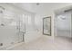 Bright bathroom with a walk-in shower, soaking tub, and large tile flooring at 724 Step Beach St, Las Vegas, NV 89138