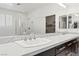 Elegant bathroom features double sinks with quartz counters, a glass shower, and modern faucets at 724 Step Beach St, Las Vegas, NV 89138