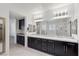 Bright bathroom featuring dual sinks, a large mirror, and modern lighting at 724 Step Beach St, Las Vegas, NV 89138