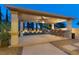 Outdoor living space with a bar area, seating, putting green, and professional landscaping for entertaining at 724 Step Beach St, Las Vegas, NV 89138