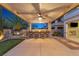 Inviting outdoor bar with seating, stylish lighting, and a putting green, creating the perfect entertainment space at 724 Step Beach St, Las Vegas, NV 89138