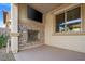 Covered patio featuring a stone fireplace with mounted television for relaxing outside year round at 724 Step Beach St, Las Vegas, NV 89138