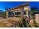 Outdoor kitchen with a built-in grill, bar seating, and a spacious patio area at 724 Step Beach St, Las Vegas, NV 89138