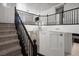 Carpeted staircase with dark wooden railing leads to second-floor hallway with chandelier above at 724 Step Beach St, Las Vegas, NV 89138