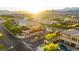 Beautiful view of a neighborhood with mature trees, lush landscaping, and mountains in the background at 724 Step Beach St, Las Vegas, NV 89138