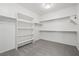 Walk-in closet with built in shelving and carpeted floors at 724 Step Beach St, Las Vegas, NV 89138