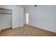Neutral carpeted bedroom with a walk-in closet and open doors to hallway at 7927 W Oquendo Rd, Las Vegas, NV 89113