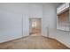 View of bedroom through double doors, with cozy carpet and ample light at 7927 W Oquendo Rd, Las Vegas, NV 89113
