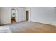 Spacious bedroom showcasing neutral carpet, a large arched entryway and bright white walls at 7927 W Oquendo Rd, Las Vegas, NV 89113