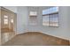 Spacious bedroom featuring neutral carpets and many windows for natural lighting at 7927 W Oquendo Rd, Las Vegas, NV 89113