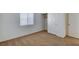 Neutral carpeted bedroom featuring a large window and closet space at 7927 W Oquendo Rd, Las Vegas, NV 89113
