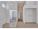 Inviting entryway with tile flooring, leading to carpeted living spaces and a room with built-in shelving at 7927 W Oquendo Rd, Las Vegas, NV 89113