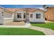Charming single-story home with a well-maintained front lawn, desert landscaping, and a two-car garage at 7927 W Oquendo Rd, Las Vegas, NV 89113