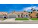 Charming single-story home with a well-maintained front lawn, desert landscaping, and a two-car garage at 7927 W Oquendo Rd, Las Vegas, NV 89113