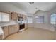 Charming kitchen with laminate countertops, natural wood cabinets, and tile-patterned flooring at 7927 W Oquendo Rd, Las Vegas, NV 89113