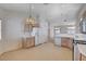 Open-concept kitchen with wooden cabinets and an adjoining view of the dining and living area at 7927 W Oquendo Rd, Las Vegas, NV 89113