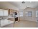 Bright kitchen features laminate countertops, wood cabinets, and a view of the dining space at 7927 W Oquendo Rd, Las Vegas, NV 89113