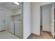 Convenient laundry room featuring appliances, storage shelving, and easy access to other rooms at 7927 W Oquendo Rd, Las Vegas, NV 89113
