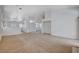 Spacious living room features neutral carpeting, recessed lighting, and an open layout at 7927 W Oquendo Rd, Las Vegas, NV 89113