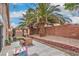 Cozy backyard featuring mature palm trees, a patio area, and a charming gazebo, perfect for outdoor relaxation at 8136 Shady Glen Ave, Las Vegas, NV 89131