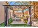 Backyard patio features a shaded pergola with seating, ideal for relaxation or entertaining in a private outdoor setting at 8136 Shady Glen Ave, Las Vegas, NV 89131