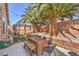 Secluded backyard with palm trees, gazebo, and a custom outdoor seating area at 8136 Shady Glen Ave, Las Vegas, NV 89131