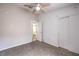 Neutral bedroom with carpet flooring, a ceiling fan, closet, and bathroom entrance at 8136 Shady Glen Ave, Las Vegas, NV 89131