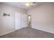 Neutral bedroom with carpet flooring, ceiling fan, closet, and bathroom entrance at 8136 Shady Glen Ave, Las Vegas, NV 89131