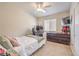 Cozy bedroom with natural light, neutral colors, carpet, gaming desk, and standard closet at 8136 Shady Glen Ave, Las Vegas, NV 89131