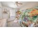 Cozy bedroom features a playful animal-themed tent over the bed, with a ceiling fan and ample natural light at 8136 Shady Glen Ave, Las Vegas, NV 89131