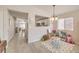 Bright dining area with wood floors, playful decor, and an open view into the kitchen and living areas at 8136 Shady Glen Ave, Las Vegas, NV 89131