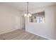 Light dining room area featuring a modern chandelier with doorway leading to living area at 8136 Shady Glen Ave, Las Vegas, NV 89131