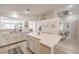 Bright and airy kitchen with white cabinetry, a center island, and modern fixtures at 8136 Shady Glen Ave, Las Vegas, NV 89131