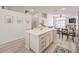 Open kitchen with a large island, white cabinetry, and views to the living area at 8136 Shady Glen Ave, Las Vegas, NV 89131