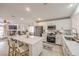 Modern kitchen featuring white cabinets, stainless steel appliances, and a large center island with seating at 8136 Shady Glen Ave, Las Vegas, NV 89131