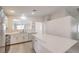 This spacious kitchen offers white cabinets, stone countertops, and modern stainless steel appliances at 8136 Shady Glen Ave, Las Vegas, NV 89131
