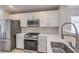 Modern kitchen featuring stainless steel appliances, white cabinets, white countertops, and subway tile backsplash at 8136 Shady Glen Ave, Las Vegas, NV 89131