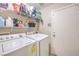 Convenient laundry room with modern washer and dryer, shelving, and ample storage space near the backdoor at 8136 Shady Glen Ave, Las Vegas, NV 89131