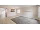 Living room with carpet and wood floors, featuring a view of the kitchen through a large opening at 8136 Shady Glen Ave, Las Vegas, NV 89131