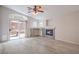 Spacious living room featuring a stone fireplace, a vaulted ceiling, wood floors, and sliding glass doors at 8136 Shady Glen Ave, Las Vegas, NV 89131