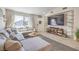 Comfortable living room featuring a sectional sofa, large window, and ample natural light at 8136 Shady Glen Ave, Las Vegas, NV 89131