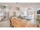Bright living room with wood floors, neutral colors, modern furniture, and access to the backyard patio at 8136 Shady Glen Ave, Las Vegas, NV 89131