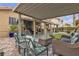 Backyard patio features multiple seating areas and well-maintained landscaping at 8216 Brittany Harbor Dr, Las Vegas, NV 89128