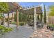 Cozy backyard patio with shaded seating and beautiful landscaping at 8216 Brittany Harbor Dr, Las Vegas, NV 89128