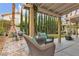 Backyard patio features comfortable wicker chairs and lovely landscaping at 8216 Brittany Harbor Dr, Las Vegas, NV 89128