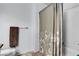 Bathroom with white tiled shower featuring patterned curtain, neutral colored floors and a mounted towel rack at 8216 Brittany Harbor Dr, Las Vegas, NV 89128