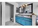 Bathroom featuring dual sinks, granite countertop, blue cabinets, and tiled floors at 8216 Brittany Harbor Dr, Las Vegas, NV 89128