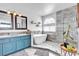 Luxurious bathroom with soaking tub, dual vanity, walk-in shower with glass enclosure, and marble accent wall at 8216 Brittany Harbor Dr, Las Vegas, NV 89128