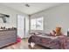 Bedroom with wood-look floors, neutral walls, blind-covered windows, and a dresser at 8216 Brittany Harbor Dr, Las Vegas, NV 89128