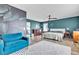 Spacious bedroom with en-suite bath features laminate floors, teal walls, modern ceiling fan and a sitting area at 8216 Brittany Harbor Dr, Las Vegas, NV 89128